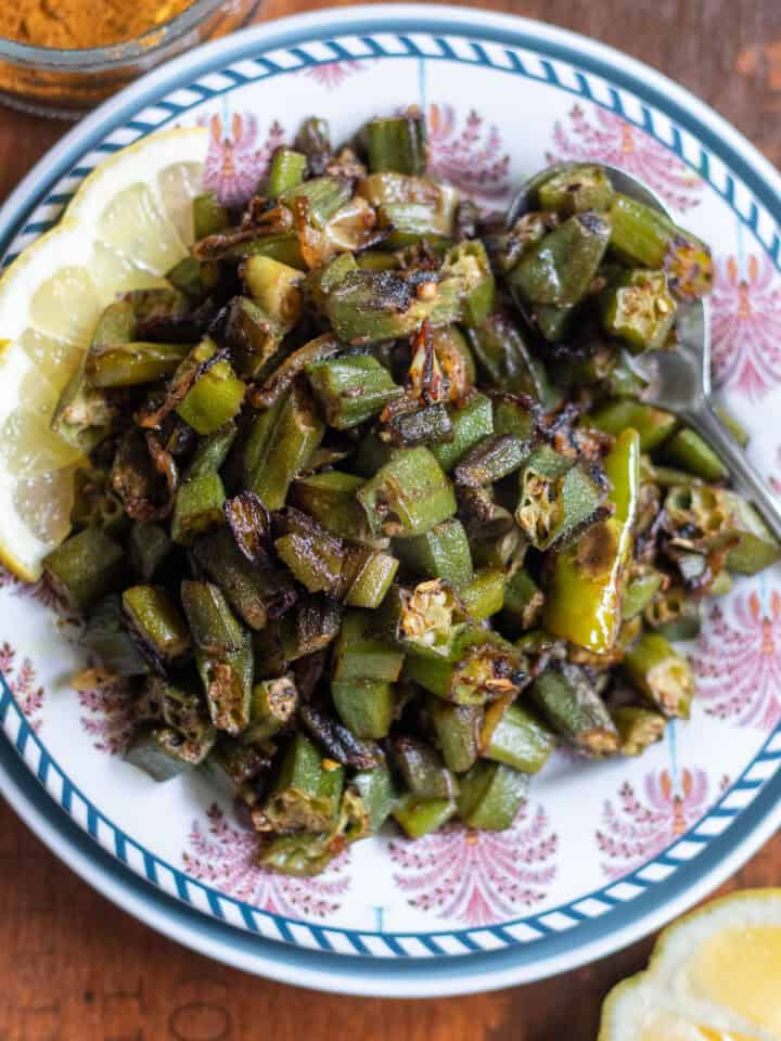 top down view of achari bhindi on a wooden tray