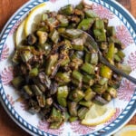 top down view of achari bhindi on a wooden tray