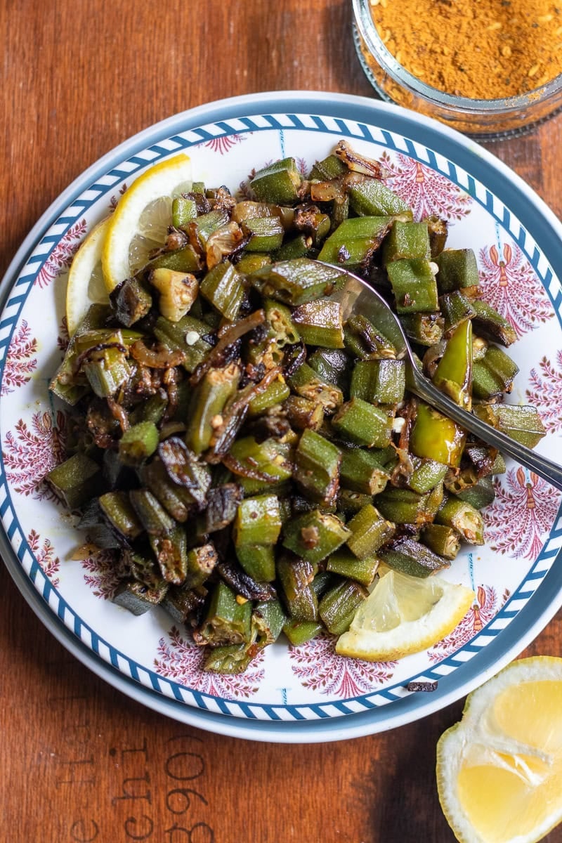 top down view of achari bhindi on a wooden tray