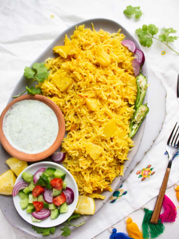 Hara Masala Chicken in a dish with onions and a sliced chili