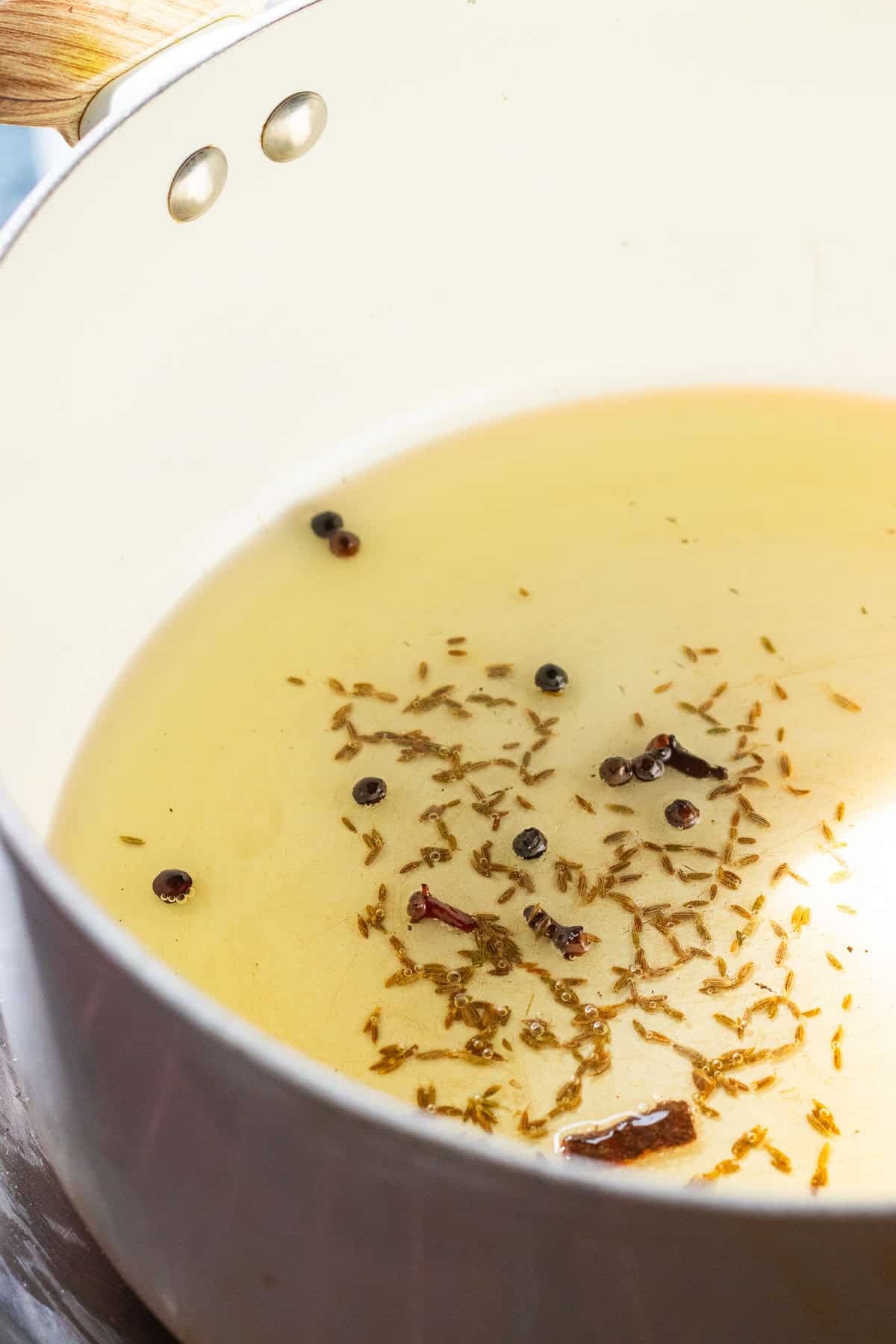 whole spices sizzling in hot oil.