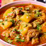 A bowl with Aloo Gosht, a meat and potato stew.