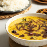 Moong ki daal in a bowl, rice in the background
