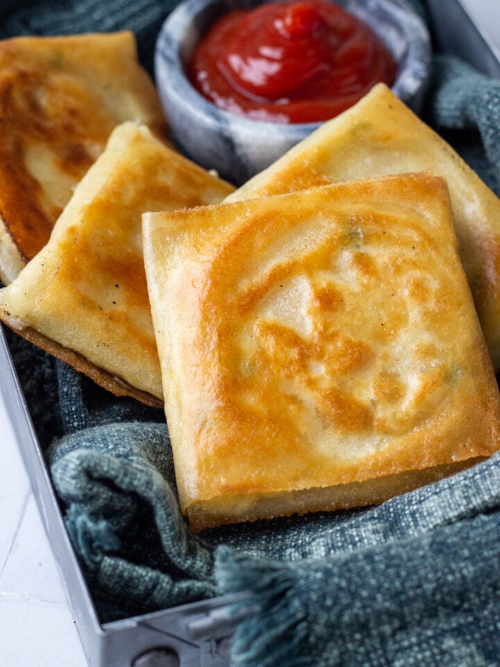 Box Patties in a metal tray with ketchup