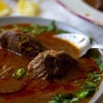 a bowl of nihari with a spoon in it