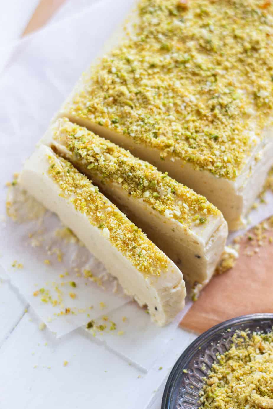 A ¾ shot of frozen Kulfi partially sliced