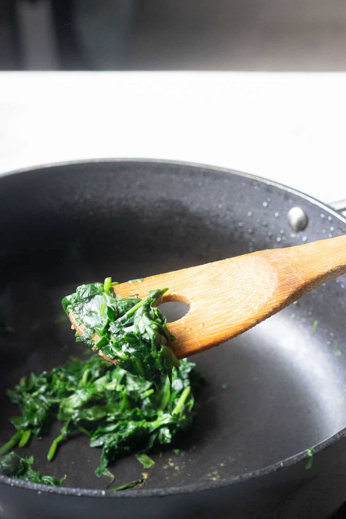 spinach cooking in a braiser