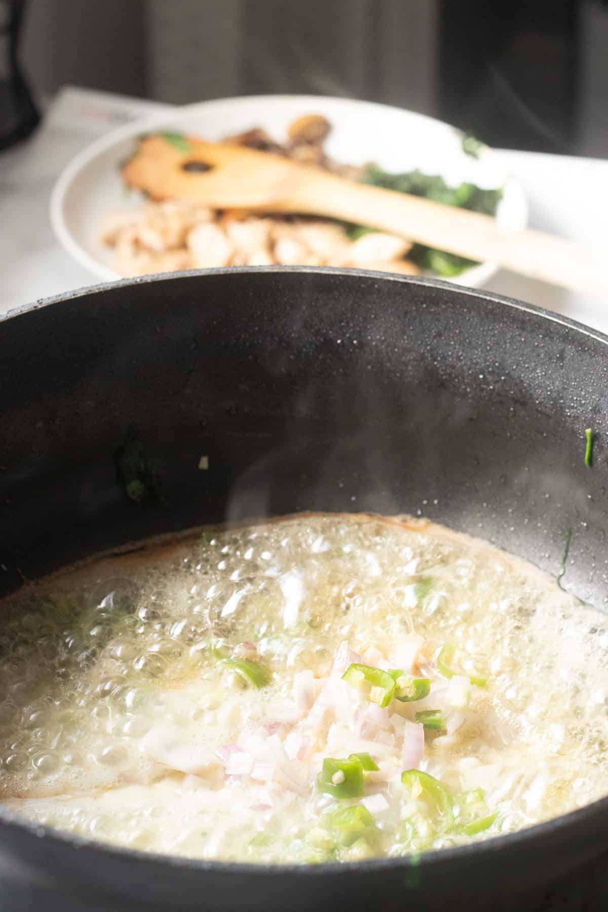 butter melting with green chilies and onions