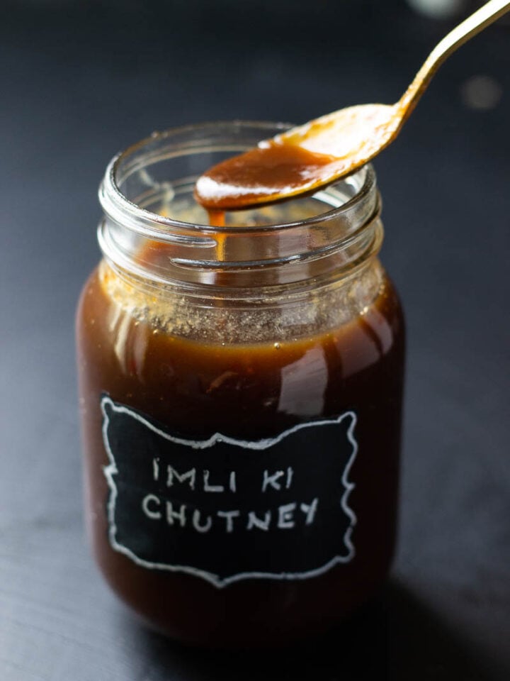 Imli ki Chutney dripping from a spoon back into the jar