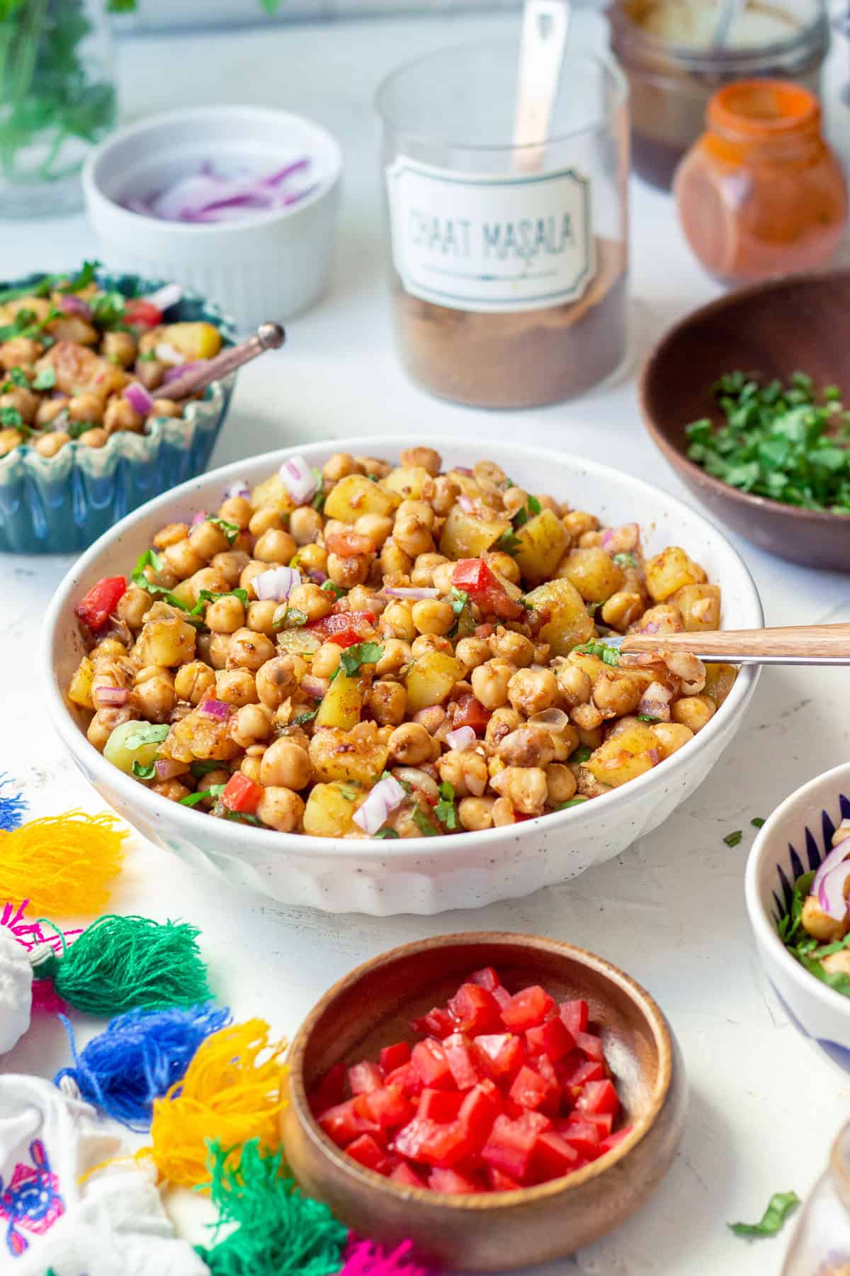 Chana Chaat in a bowl with a spoon, a little cilantro 