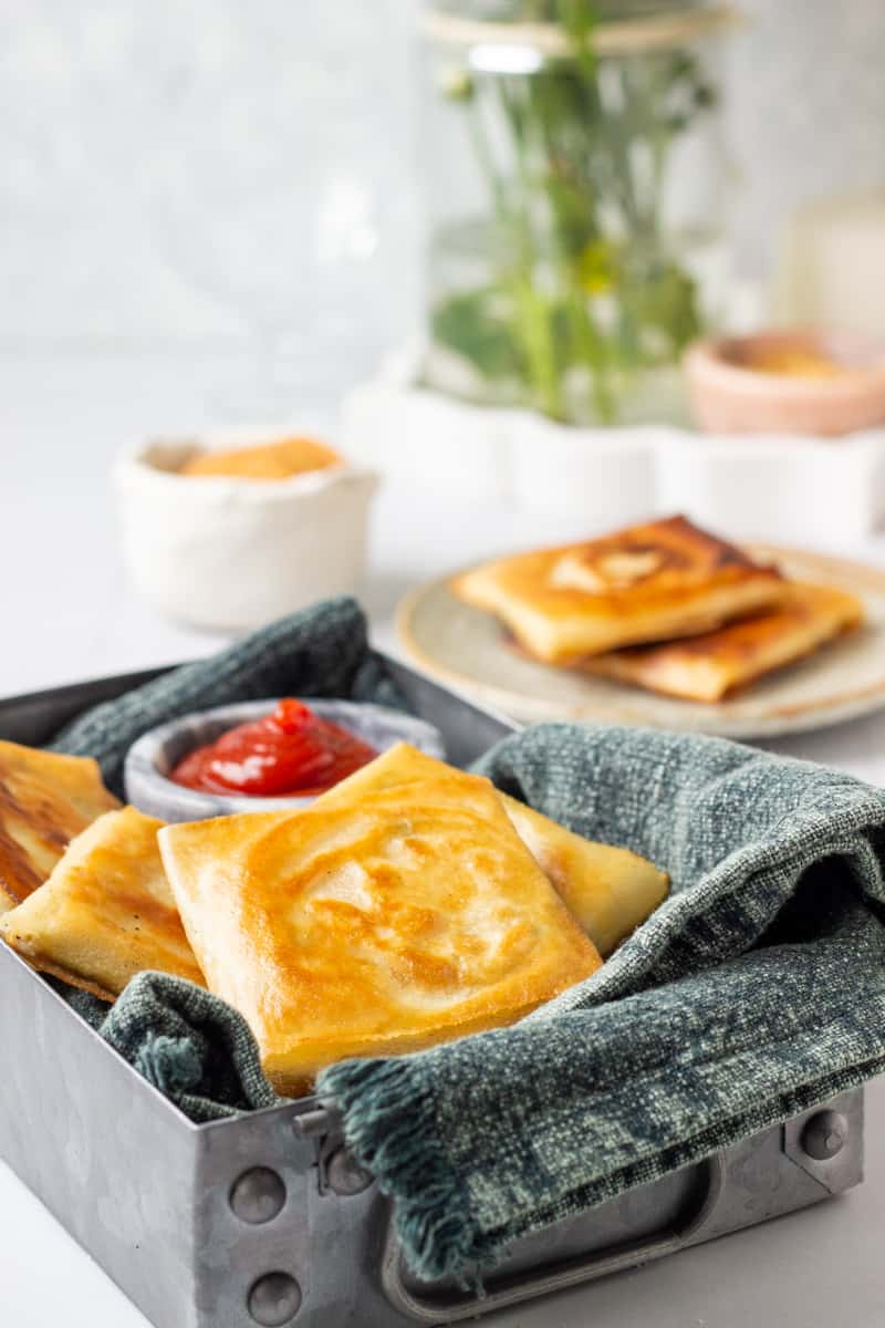 a tray of box patties, two more in a plate in the background