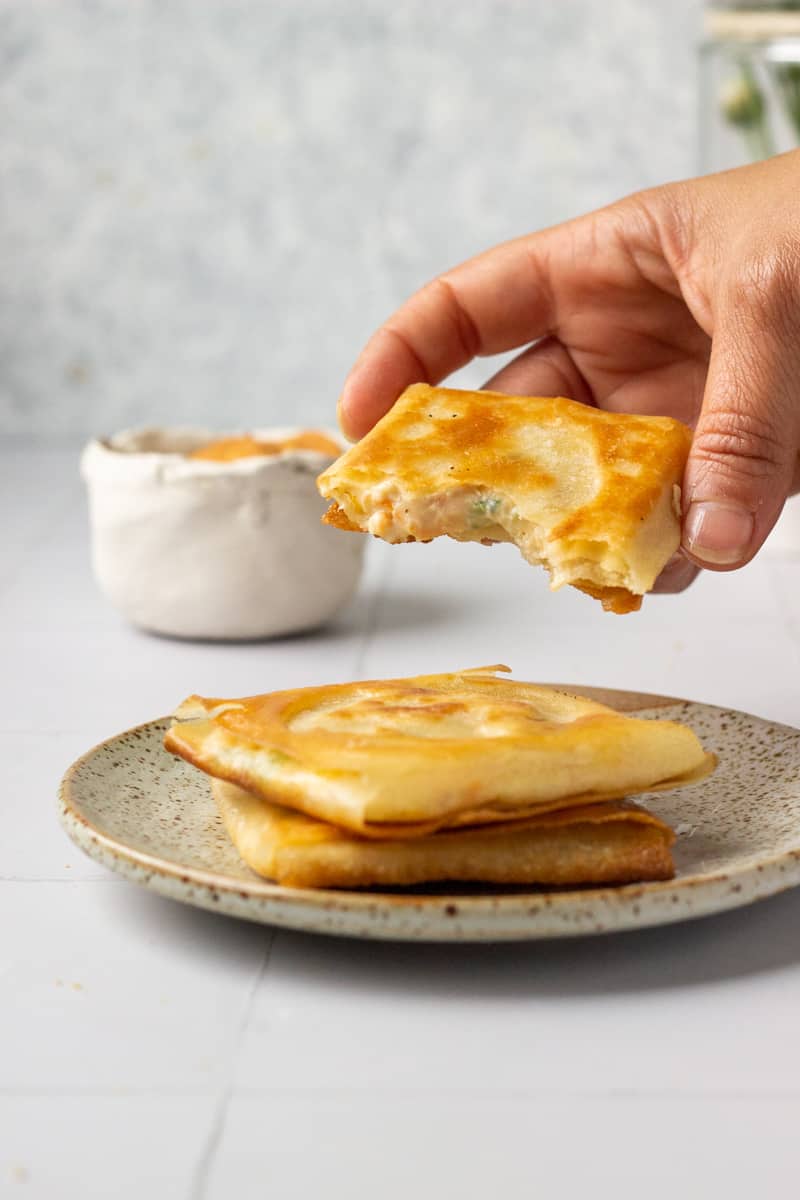 two box patties stacked, one hand held, filling showing