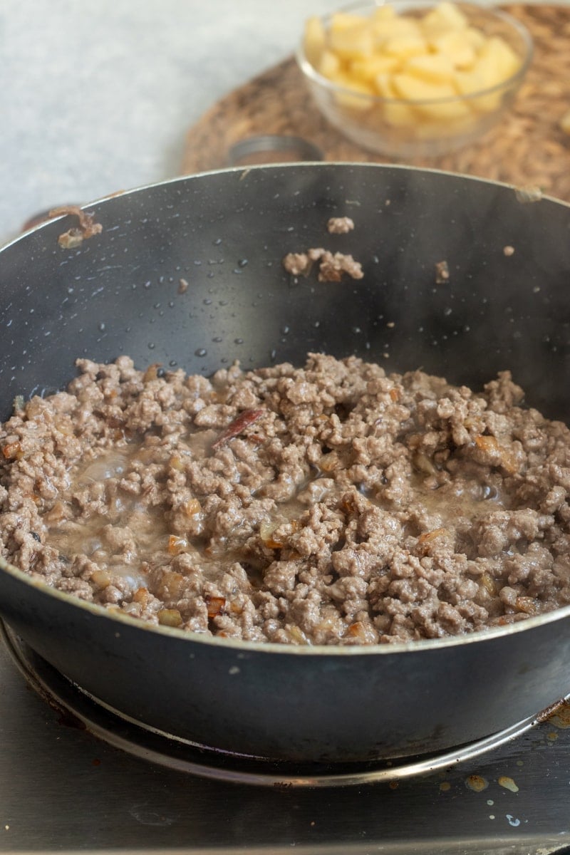 crumbled ground beef in a black wok