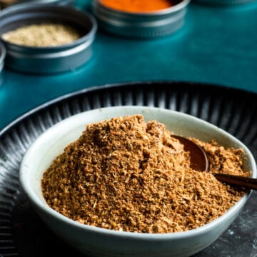 Pakistani Chaat Masala mix in a bowl, spices in background