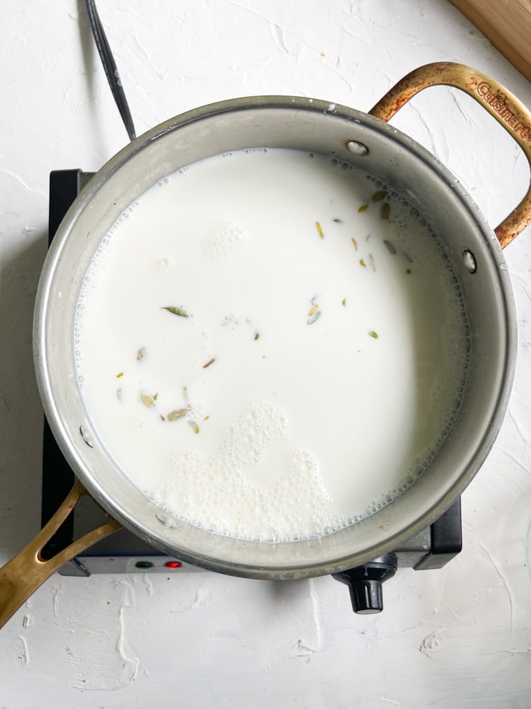 milk mixture for rasmalai simmering in a pan