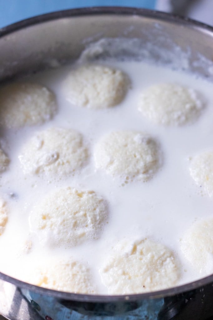 rasmalai cooking stovetop in a pot
