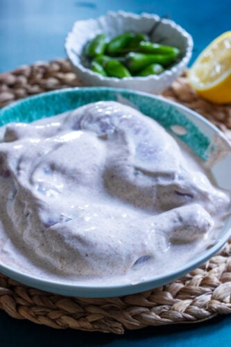 chicken being marinated