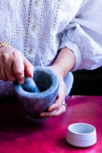 person freshly grinding cardamom