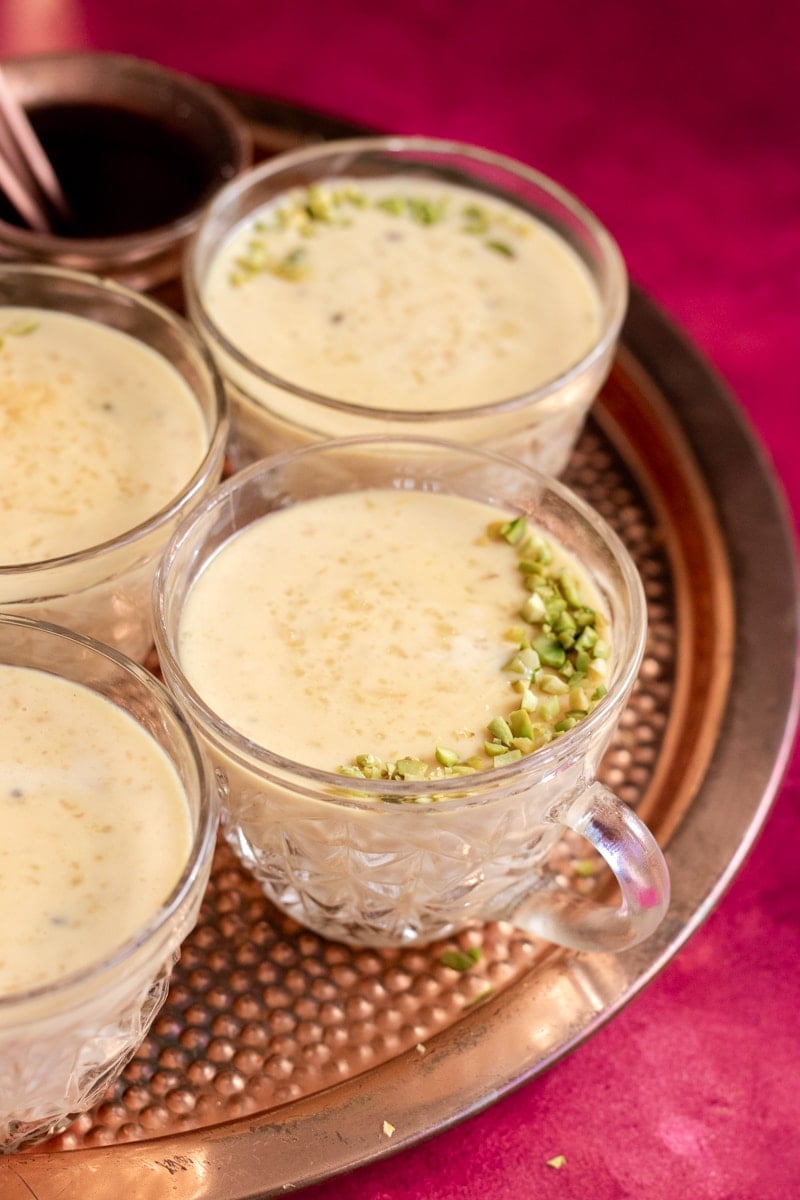 cups of rice kheer on a copper tray