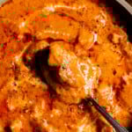 Close up of a dish of Chicken Handi with a spoon in it