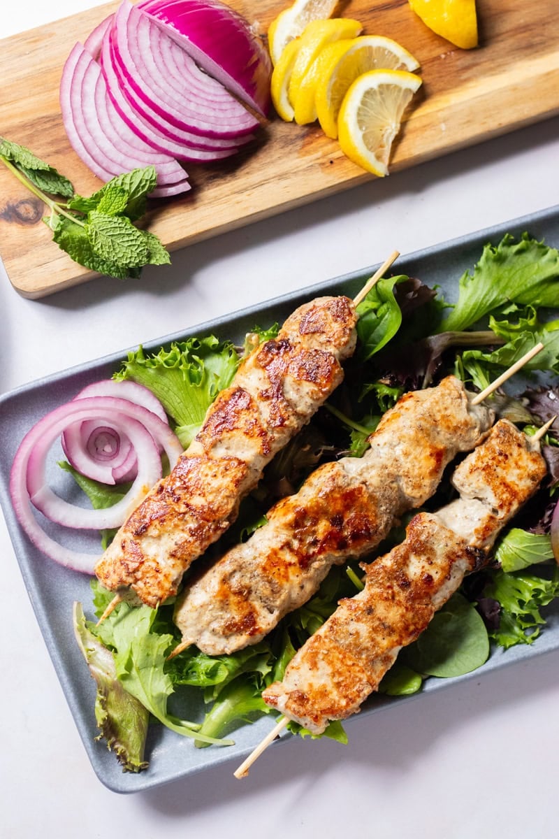 top down of 3 skewers of malai boti