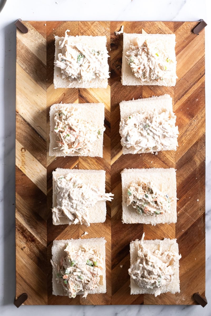 open faced chicken salad sandwiches on a board