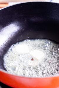 butter and cloves in a wok