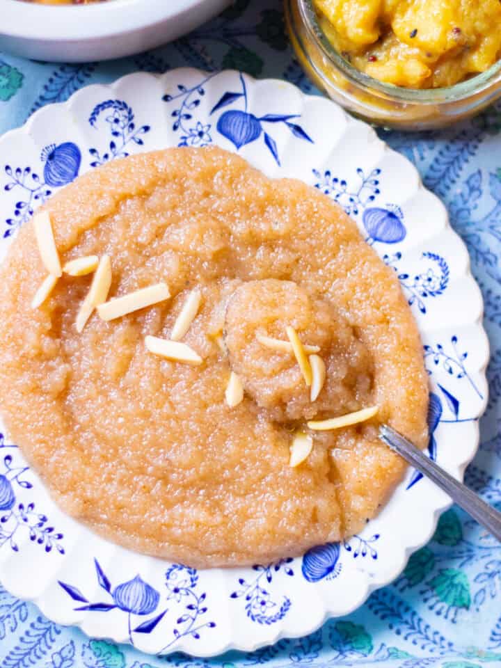 soft sooji ja halwa garnished with slivered almonds and on a plate
