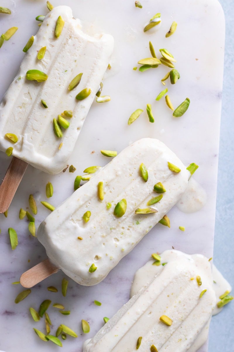 top down view of pista kulfi with some pistachios scattered over top.